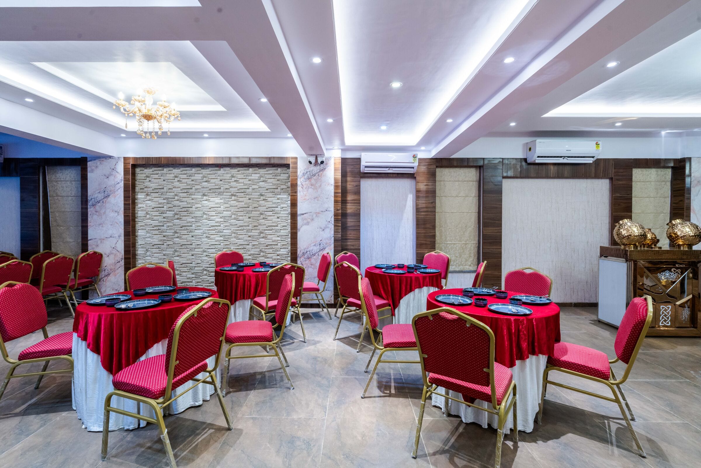 Round tables in red and white, set for dinner
