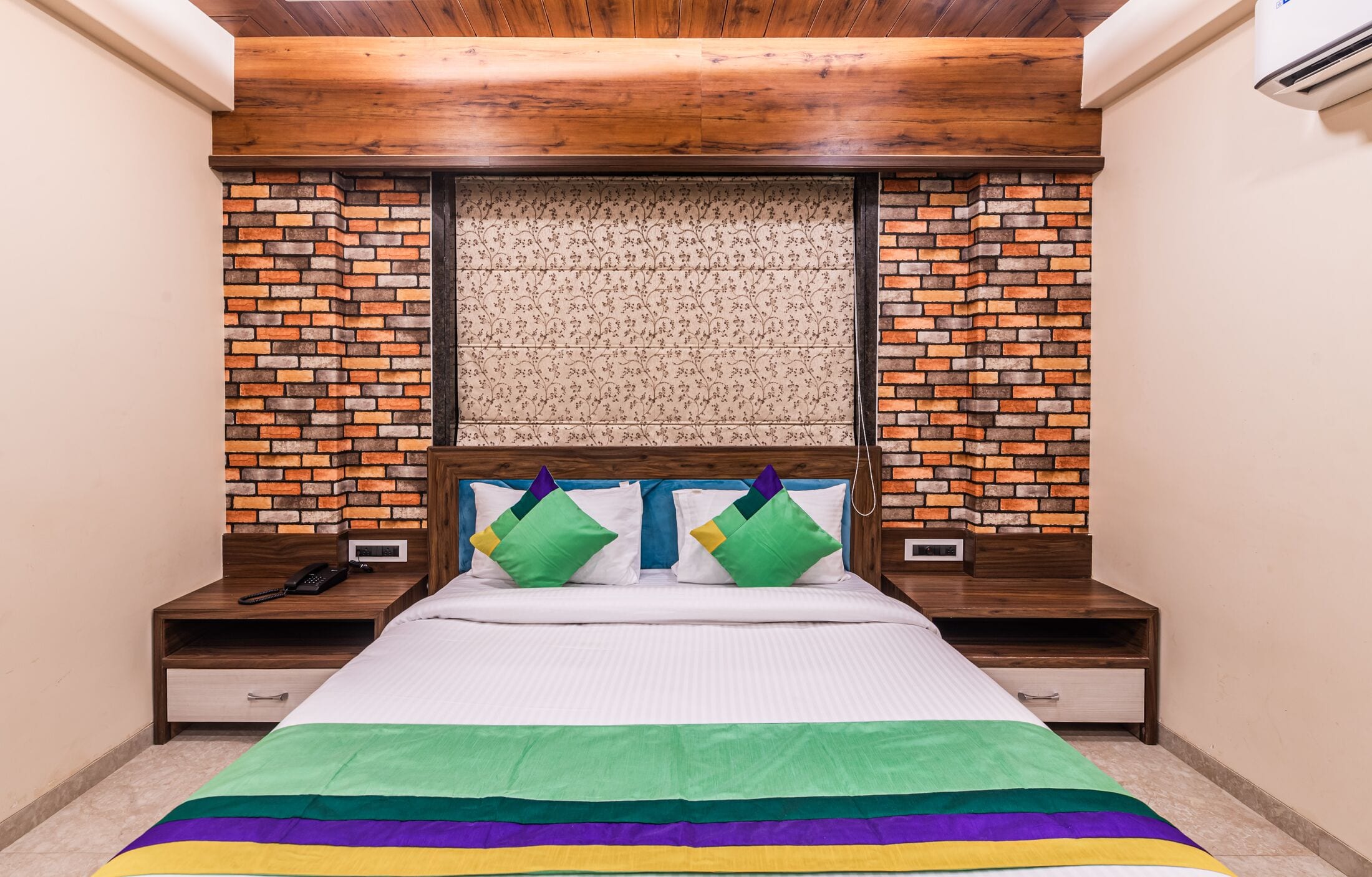 The Executive room straight on, brick on either side of the bed