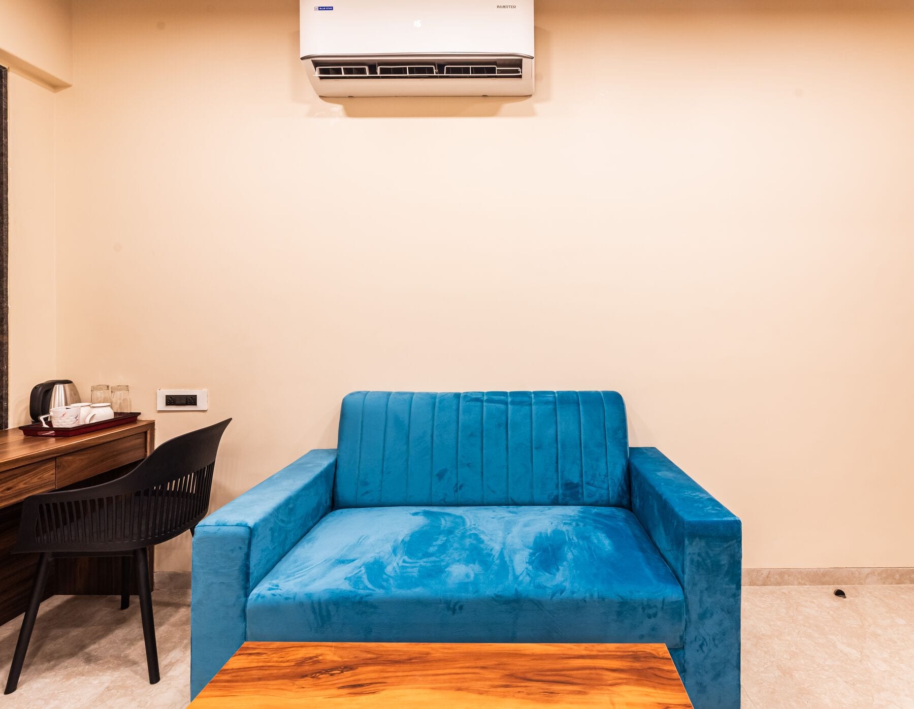 The blue velvet sofa and work desk in the Suite