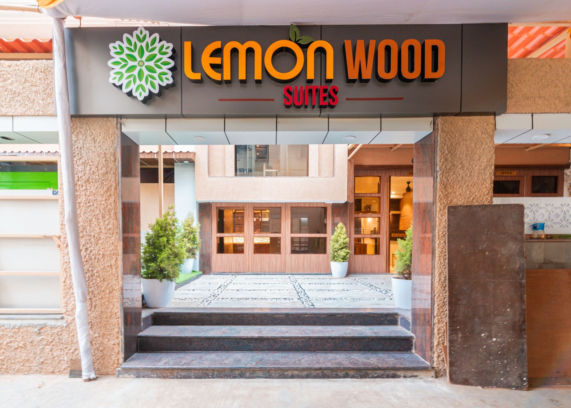The Lemonwood Suites sign above the entrance steps