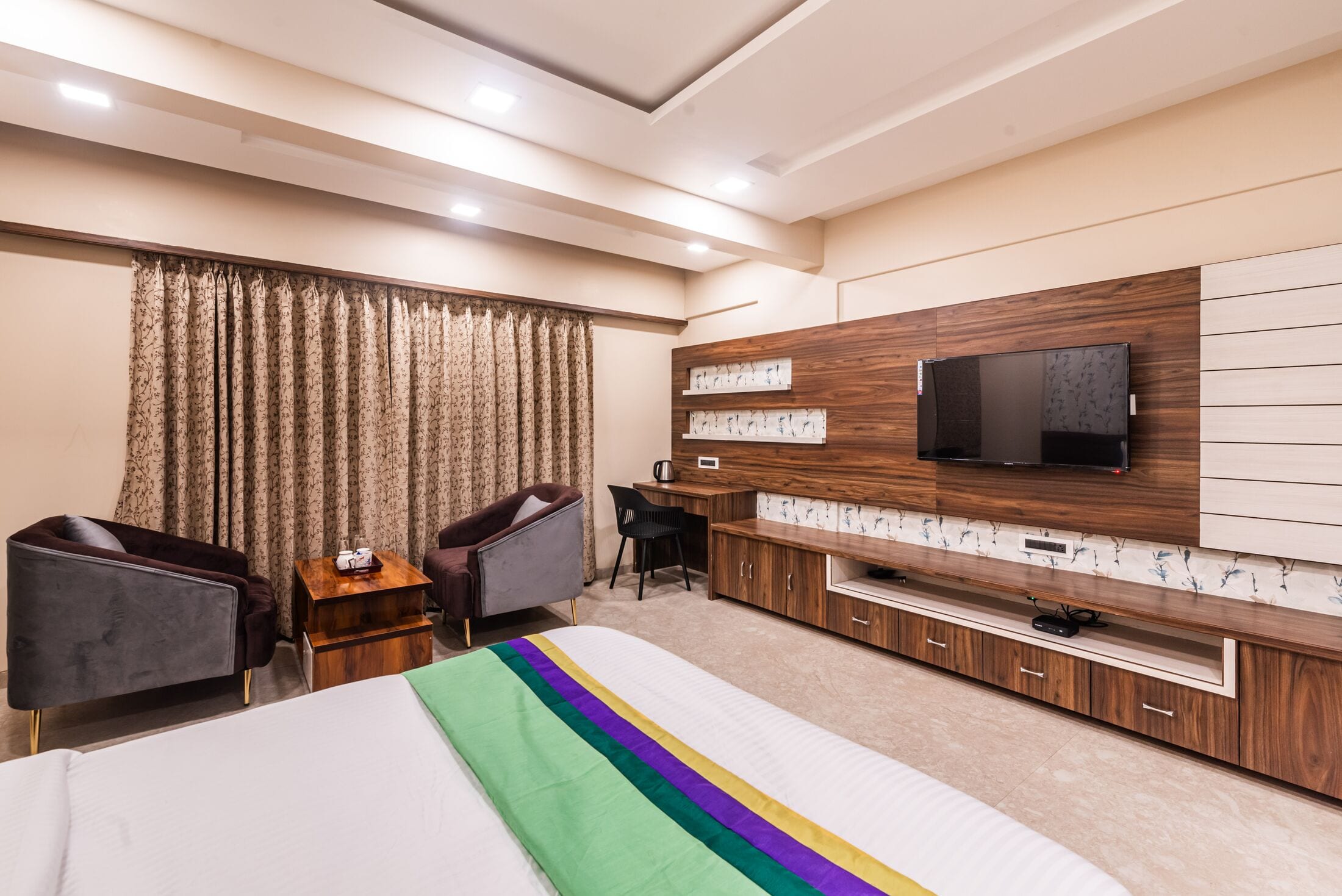 The walnut media unit and armchairs in the Super Deluxe